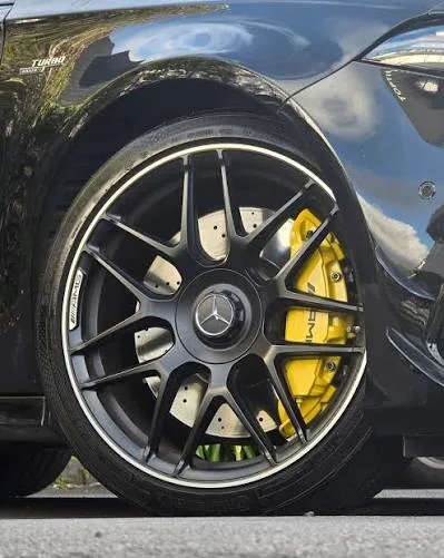 Mercedes-AMG with yellow ceramic brake calipers behind a black wheel