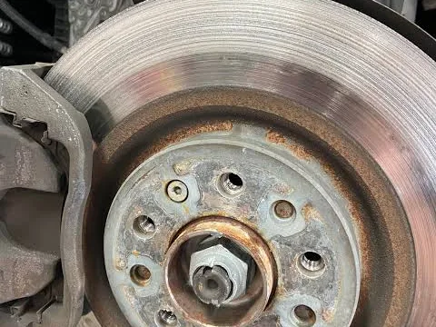 Mercedes-Benz brake rotor badly scored from metal-on-metal contact after the pads wore to 0 mm