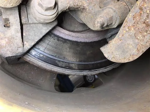 Heavy rust buildup on the face of a Mercedes-Benz brake rotor