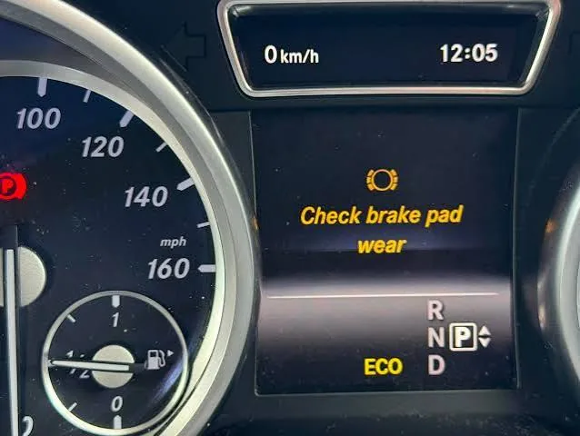 Mercedes-Benz instrument cluster showing the Check brake pad wear message