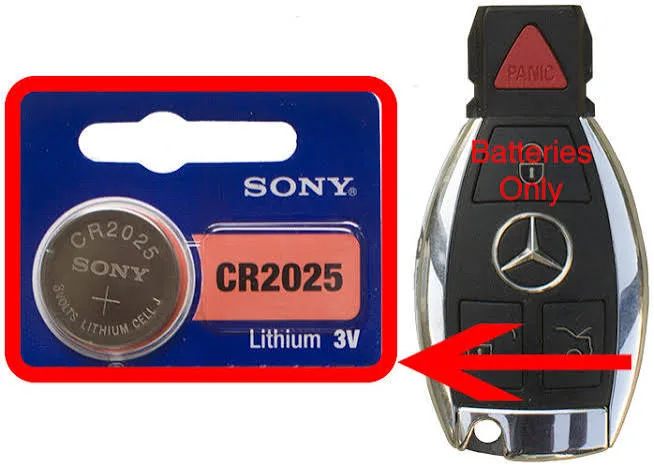 CR2025 coin battery next to an older chrome Mercedes-Benz smart key