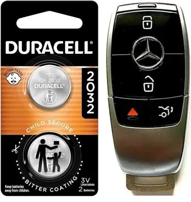 CR2032 coin battery next to a newer Mercedes-Benz key fob