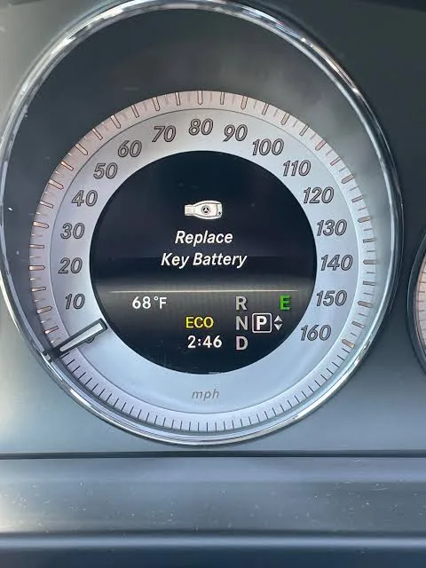 Older Mercedes-Benz instrument cluster showing the Replace Key Battery message