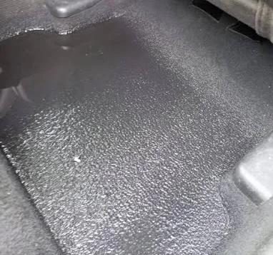 Water pooled on the floor under the carpet of a Mercedes-Benz C-Class from a clogged sunroof drain