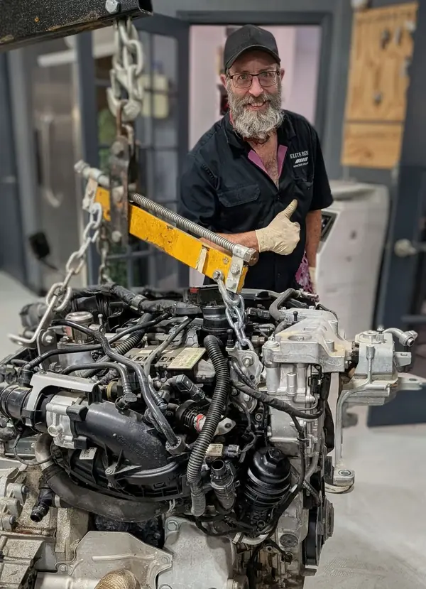 Factory-trained Mercedes-Benz master technician rebuilding a Mercedes engine at Elite Benz in Summerville